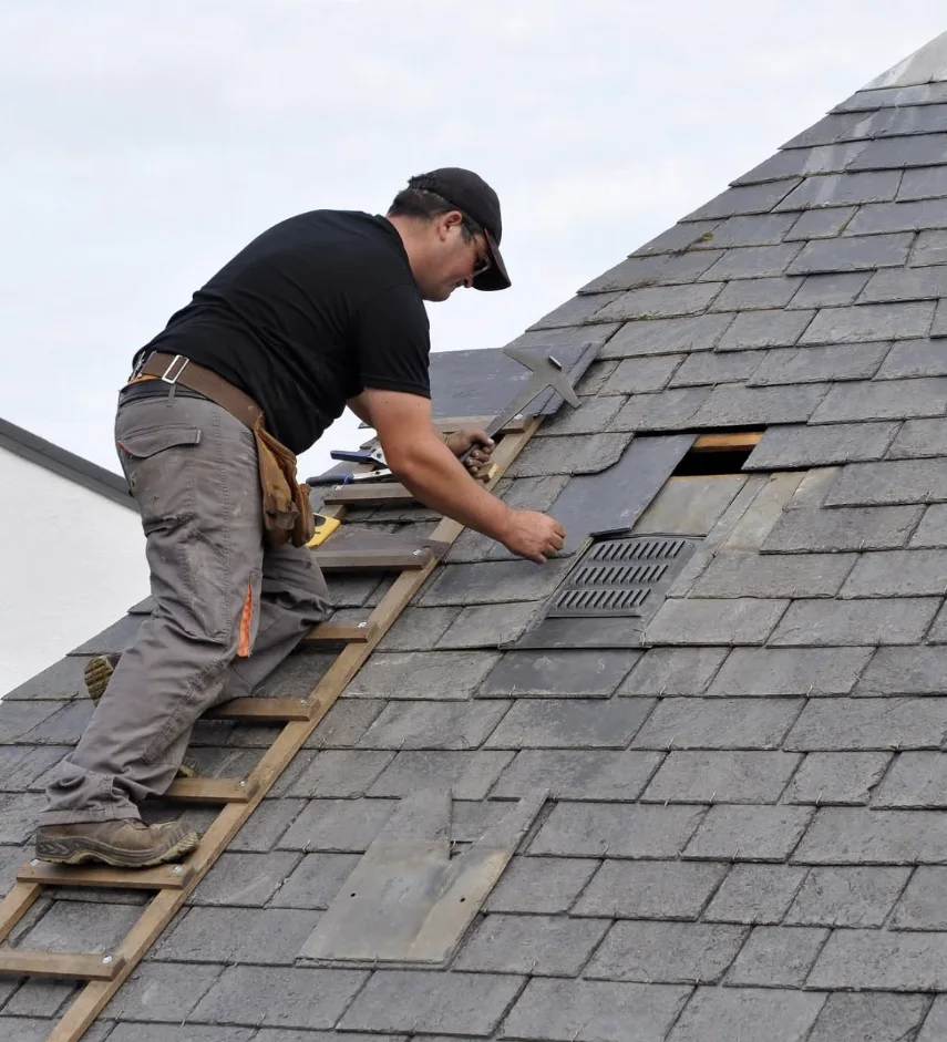 Professional Roofing Contractor Bismarck ND inspecting and repairing residential roof shingles.